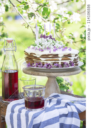 beautiful cake with candles on the background of nature 114106886