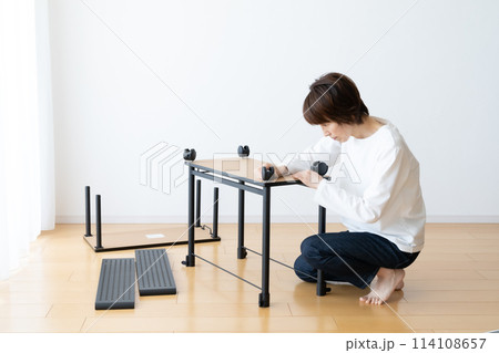 キャスター付きワゴンを組み立て、分解する女性 114108657