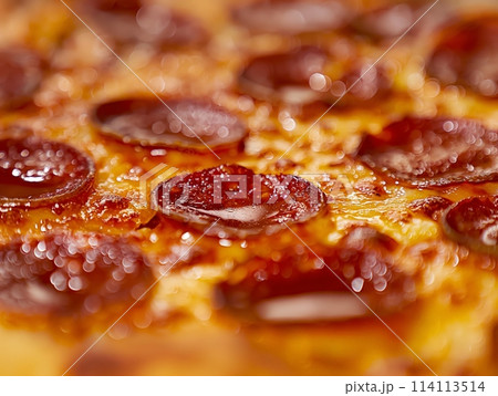 Macro shot highlighting the texture of gooey melted cheese and spicy pepperoni on pizza, evoking appetite and warmth. Macro shot highlighting the texture of gooey melted cheese and spicy pepperoni on pizza, evoking appetite and warmth. 114113514
