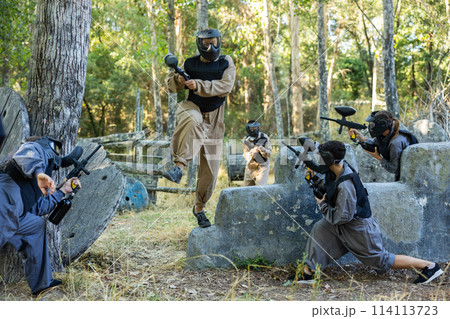 Skillful paintball team attacking hostile positions Skillful paintball team attacking hostile positions 114113723