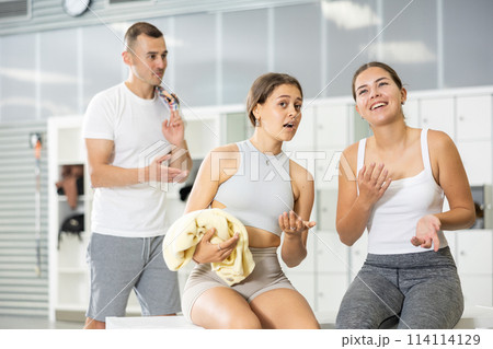 Young man intervenes in conversation between two girls in dressing room. 114114129