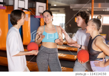 Group portrait of enthusiastic young people discussing upcoming jumping workout on trampoline in entertainment center Group portrait of enthusiastic young people discussing upcoming jumping workout on trampoline in entertainment center 114114150