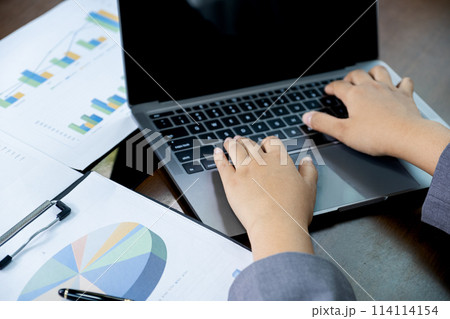 Businesswomen bookkeeper hand use laptop analysis the graph for Setting challenging business goals and ready to achieve target at home office Businesswomen bookkeeper hand use laptop analysis the graph for Setting challenging business goals and ready to achieve target at home office 114114154