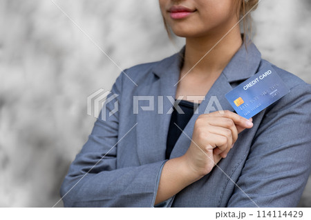 Businesswoman hand hold mock-up credit card for online shopping on smartphones, payment E-commerce, internet finance bank, spend money electronic wallet Businesswoman hand hold mock-up credit card for online shopping on smartphones, payment E-commerce, internet finance bank, spend money electronic wallet 114114429