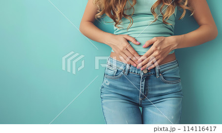 Women forming a heart shape with her hands on her waist, a touching gesture 114116417