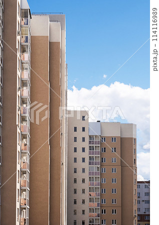 Residencial buildings facades against blue sky. 114116989