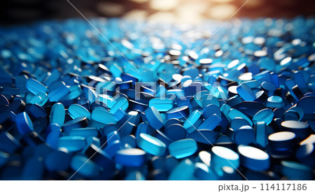 White pills on blue background 114117186