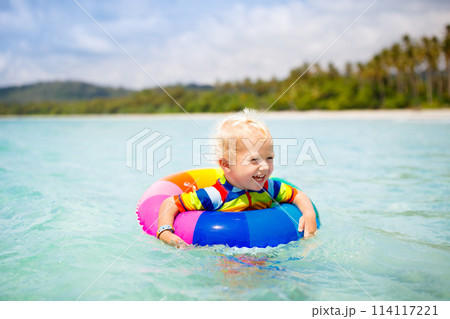 Child on tropical beach. Sea vacation with kids. 114117221