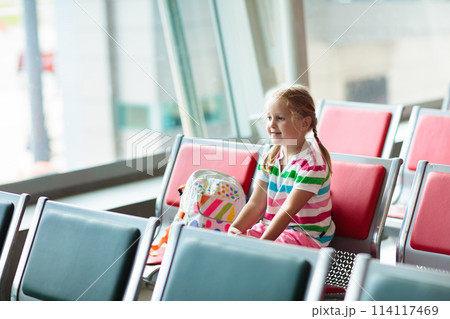 Kids travel and fly. Child at airplane in airport Kids travel and fly. Child at airplane in airport 114117469