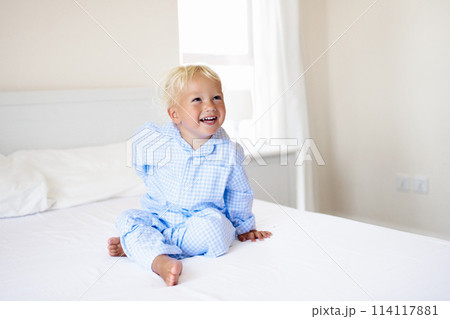 Kids in bed. Children in pajamas. Family bedroom. 114117881