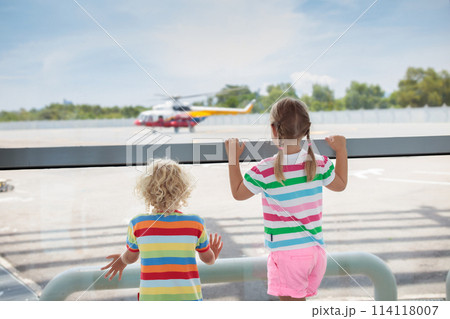 Kids travel and fly. Child at airplane in airport Kids travel and fly. Child at airplane in airport 114118007