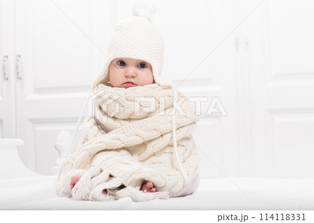 Little baby on white bed 114118331