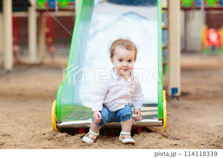 Child playing on playground. Kids swing. Child playing on playground. Kids swing. 114118339