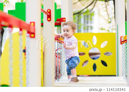 Child playing on playground. Kids swing. 114118341