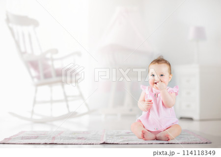 Little baby girl in white nursery Little baby girl in white nursery 114118349