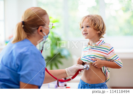 Doctor examining sick child in face mask Doctor examining sick child in face mask 114118494