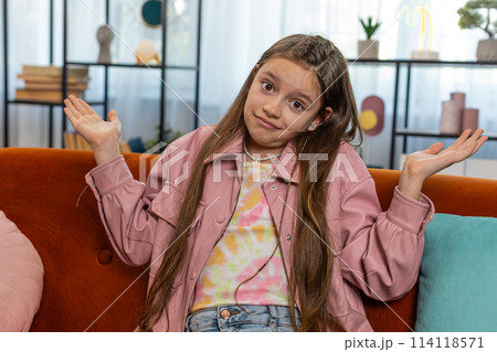 Confused child girl feeling embarrassed about ambiguous question having doubts no idea clueless Confused child girl feeling embarrassed about ambiguous question having doubts no idea clueless 114118571