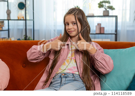 Child girl kid looking approvingly at camera showing double thumbs up like sign positive feedback 114118589