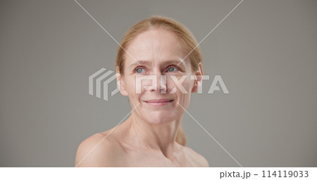 Anti age, Beauty, health and dry skin care real people concept - beautiful middle-aged mature Caucasian woman in her 50s looking at the camera with a slight smile Anti age, Beauty, health and dry skin care real people concept - beautiful middle-aged mature Caucasian woman in her 50s looking at the camera with a slight smile 114119033