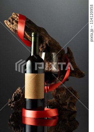 Bottle with old empty label and glass of red wine. Bottle with old empty label and glass of red wine. 114120958
