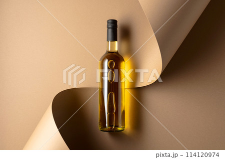 Bottle of white wine on a beige background. 114120974
