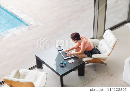 Senior digital nomad woman working at luxury villa in Phuket. andaman sea as background 114122895