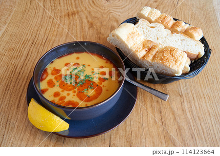 Lentil or tripe soup on wooden textured table 114123664