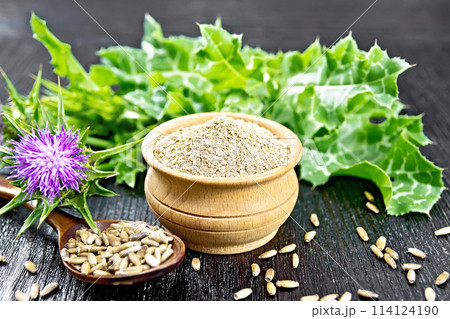 Flour milk thistle in bowl on board Flour milk thistle in bowl on board 114124190