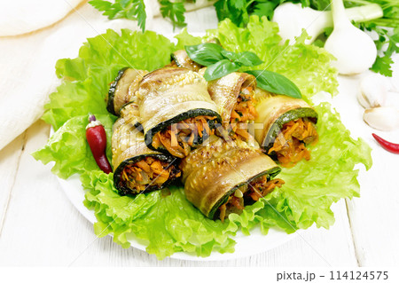 Rolls of zucchini with carrots in plate on board Rolls of zucchini with carrots in plate on board 114124575