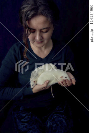 an  albino  standard rat and albino standard rat cuddles with theie owner 114124966