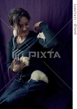 the woman holds all her five rats in her hands the woman holds all her five rats in her hands 114124972