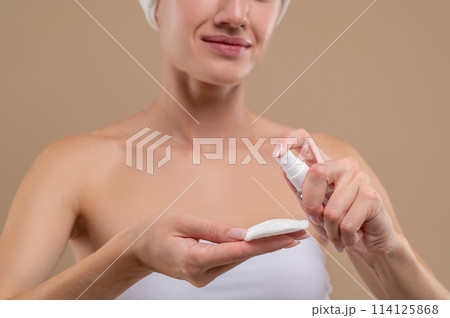 Unrecognizable woman applying tonic and moisturizing for smooth skin Unrecognizable woman applying tonic and moisturizing for smooth skin 114125868