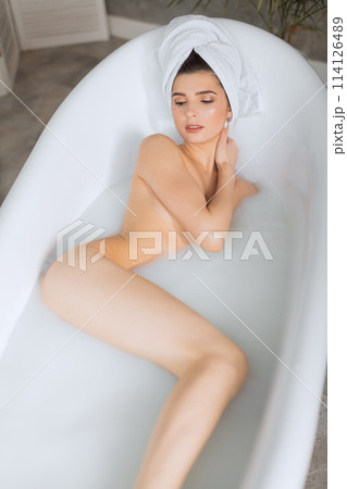 Beautiful young woman taking bath at home 114126489