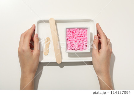 White tray with pink granules for depilation 114127094