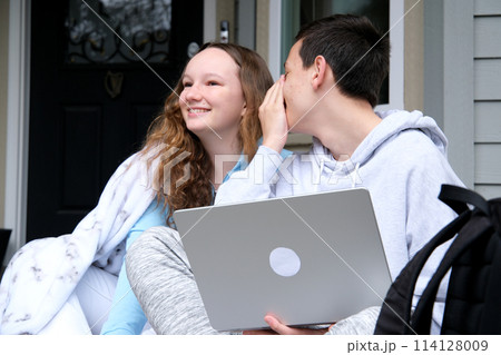 Couple of teenagers, saying things in your ear Couple of teenagers, saying things in your ear 114128009