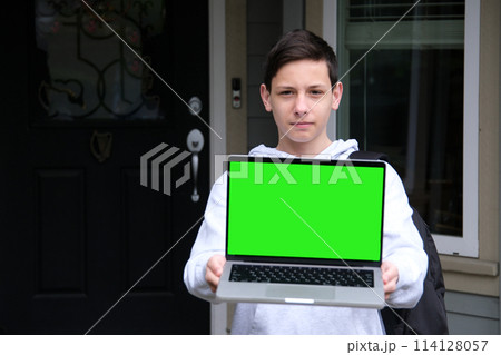 Amazed excited caucasian young man peeking out from behind laptop, looks surprised at camera, stands on isolated white background, holds an open laptop with blank white screen, copy space, mock-up 114128057