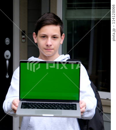 green screen laptop is a close-up teen boy in gray hoodie holding laptop with green screen product ad stern shoulder near his home delivery delicious food space for text free space photography green screen laptop is a close-up teen boy in gray hoodie holding laptop with green screen product ad stern shoulder near his home delivery delicious food space for text free space photography 114128066