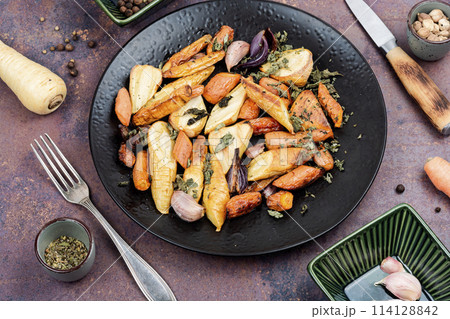 Baked sliced parsnip root and carrots. Baked sliced parsnip root and carrots. 114128842