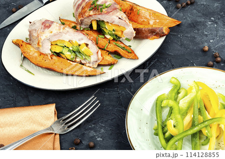 Pork roll filled and baked sweet potatoes. 114128855