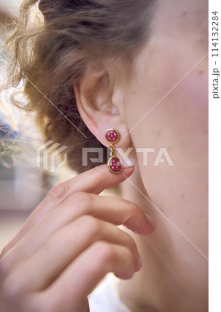 chic middle aged woman in a white vintage dress, details of the outfit 114132284