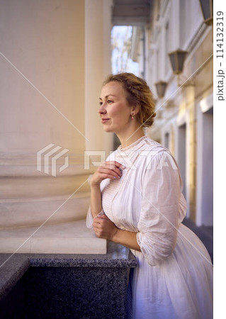 elegant middle age woman in white vintage dress near theater with antique colonnades elegant middle age woman in white vintage dress near theater with antique colonnades 114132319