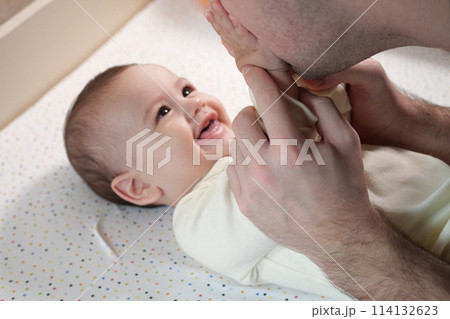Happy dad and son having fun at home. Father and baby boy in bedroom on a bright background. Tenderness, parenthood 114132623