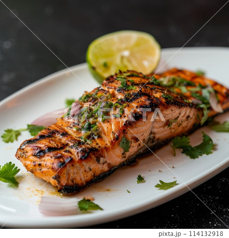 cilantro lime grilled salmon on curved white plate, good composition on a plate, photo for the restaurant menu 114132918