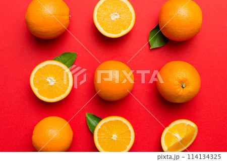 Fruit pattern of fresh orange slices on colored background. Top view. Copy Space. creative summer concept. Half of citrus in minimal flat lay 114134325
