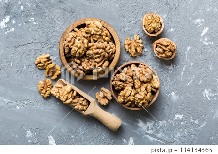 Fresh healthy walnuts in bowl on colored table background. Top view Healthy eating bertholletia concept. Super foods Fresh healthy walnuts in bowl on colored table background. Top view Healthy eating bertholletia concept. Super foods 114134365