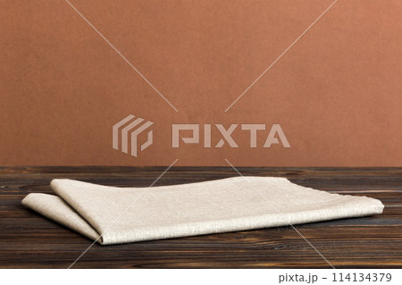 top view with gray kitchen napkin isolated on table background. Folded cloth for mockup with copy space, Flat lay. Minimal style top view with gray kitchen napkin isolated on table background. Folded cloth for mockup with copy space, Flat lay. Minimal style 114134379