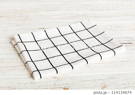 top view with white empty kitchen napkin isolated on table background. Folded cloth for mockup with copy space, Flat lay. Minimal style top view with white empty kitchen napkin isolated on table background. Folded cloth for mockup with copy space, Flat lay. Minimal style 114134674