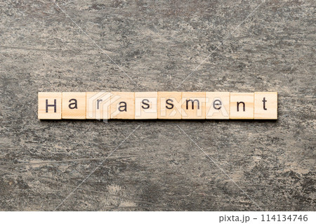 harassment word written on wood block. harassment text on cement table for your desing, concept 114134746