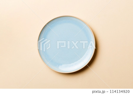 Top view of isolated of colored background empty round blue plate for food. Empty dish with space for your design Top view of isolated of colored background empty round blue plate for food. Empty dish with space for your design 114134920