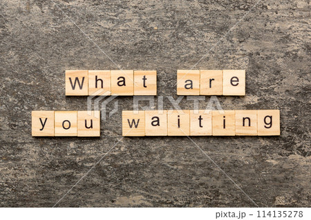 What are you waiting word written on wood block. What are you waiting text on cement table for your desing, Top view concept 114135278